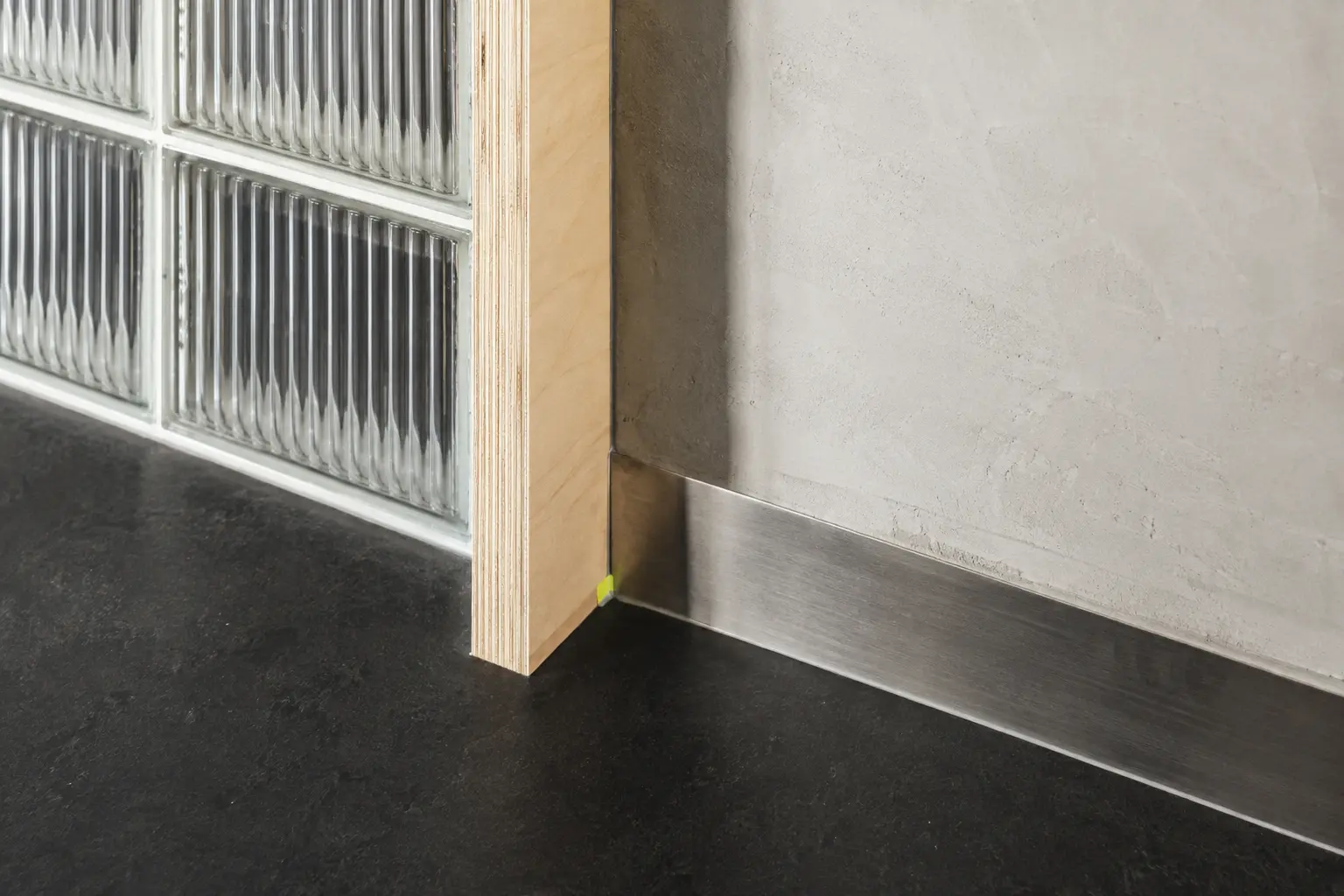 A junction of glass block, timber, plaster and steel within ROOH